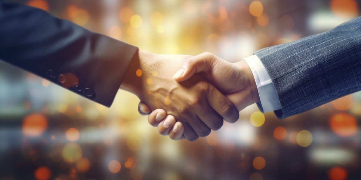 Partners shaking hands to signify business cooperation merger and acquisition joint venture